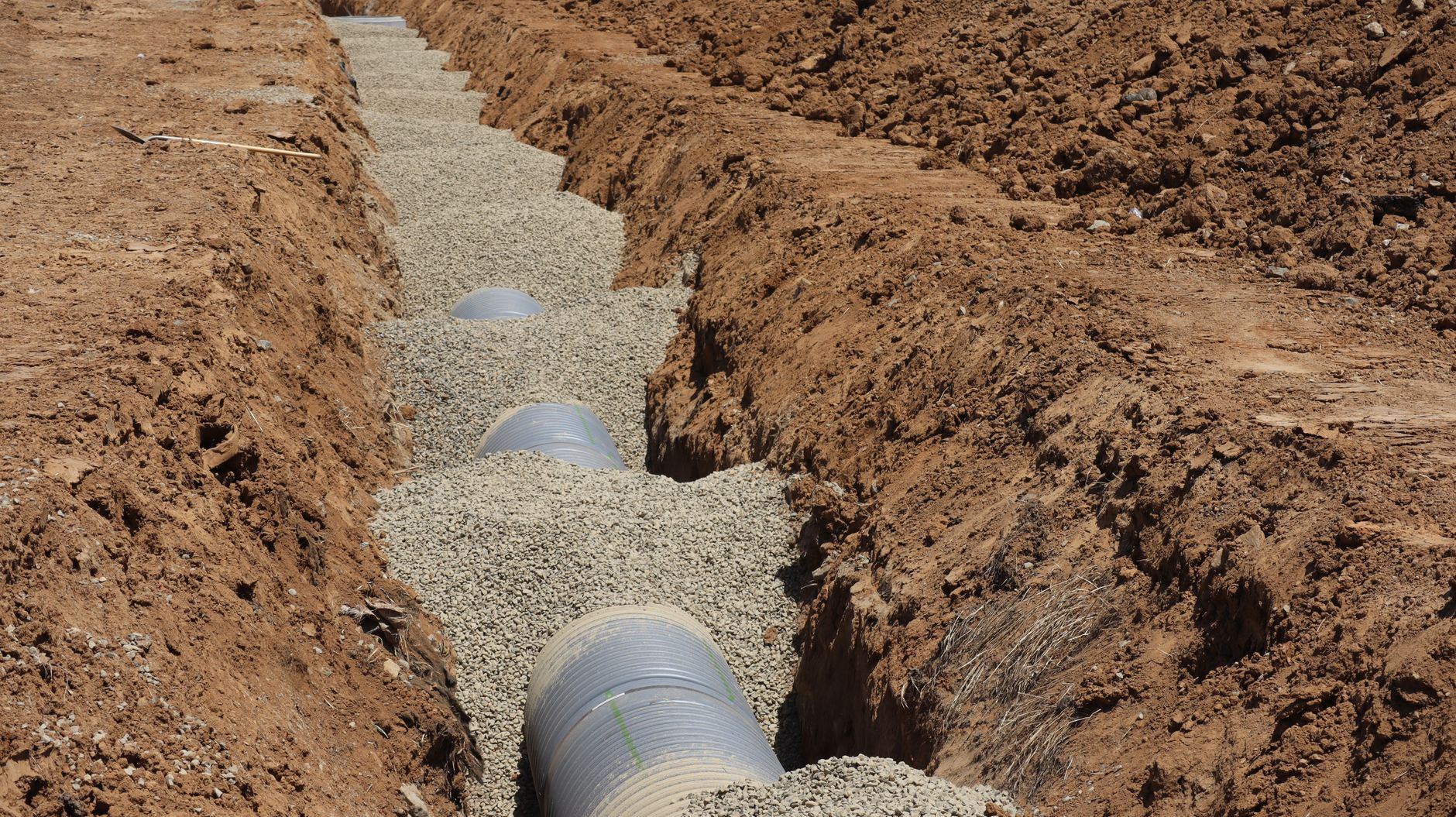 A pipe bedded in drainage metal in an open trench