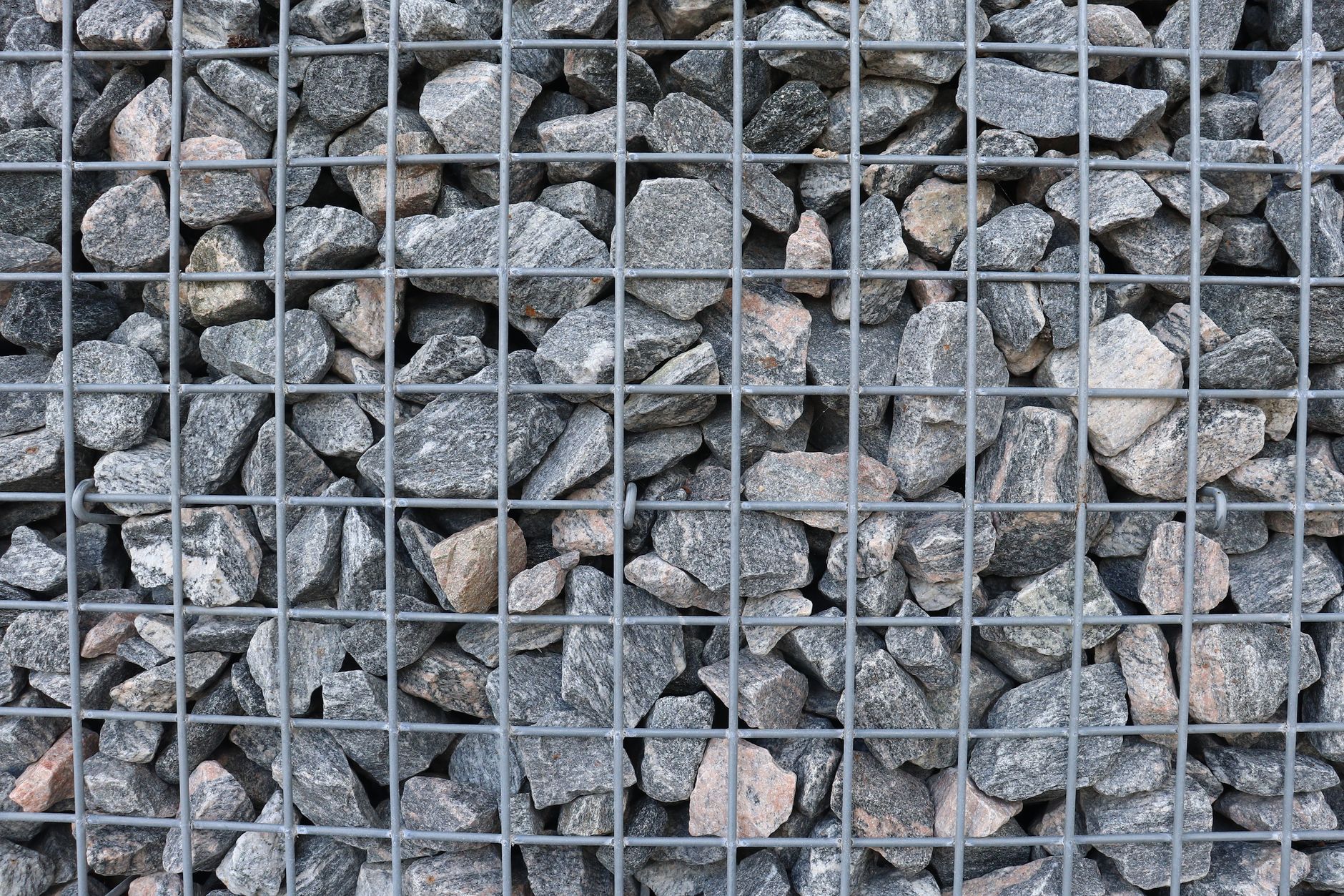 A gabion basket packed with broken rock